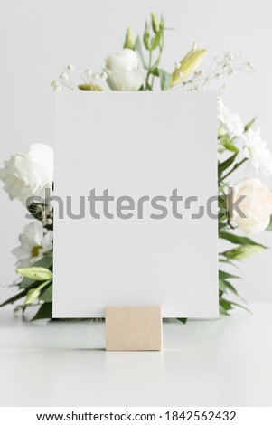 Wedding table number card mockup with a floral arrangement. Royalty-Free Stock Photo #1842562432