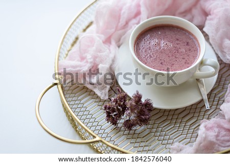 morning still life, Feminine lifestyle composition, Cup of pink tea, booster on gold tray on white background, good morning , slow living, copy space, closeup