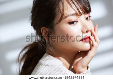 
Beauty portrait of young Asian women on light and shadow background Royalty-Free Stock Photo #1842594886