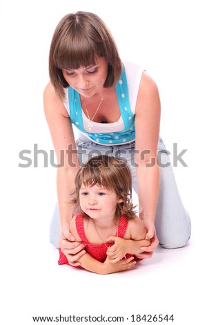 A young beautiful laughing woman holding a little girl over white background