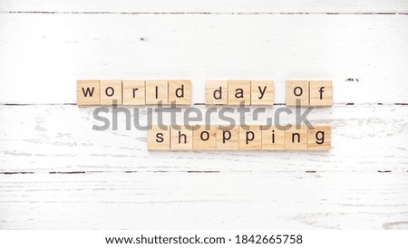 World day of shopping. words from wooden cubes with letters. photo