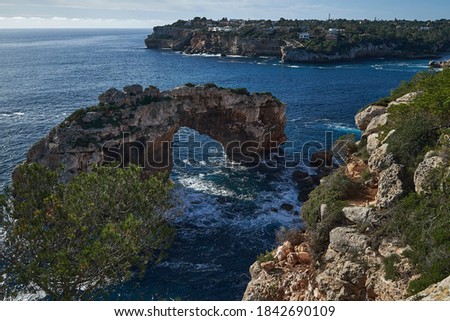 Es Pontas, a natural bridge rock on Mallorcas south coast and diving site. Royalty-Free Stock Photo #1842690109