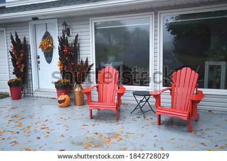 Two Red Chairs in the Front House Entrance in Autumn