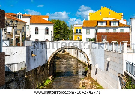 Arch bridge across the Alcobaca river in Alcobaca, Portugal Royalty-Free Stock Photo #1842742771