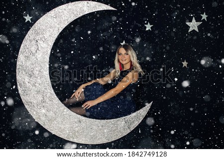 Picture of a young girl posing in the scenery of a big moon