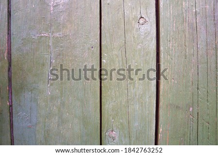 Wooden wall with shabby green paint