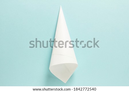 Step-by-step photo instructions on how to make a white bull from paper with your own hands. Symbol of the new year 2021. Simple crafts with children. Step 2. Collapse the cone