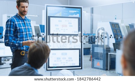 On a Meeting Chief Industrial Engineer Reports to a Specialists, Managers, Uses Digital Whiteboard to Show Statistics and New Eco Friendly Engine Concept. Sustainable Green Energy Research