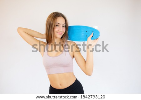 Portrait of cute girl holding skate board in hand isolated on white background