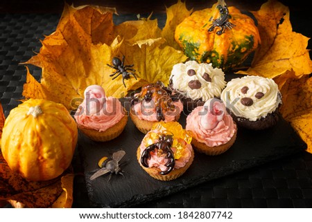 Hellooween cupcake with cream pumpkins and autumn maple leaf