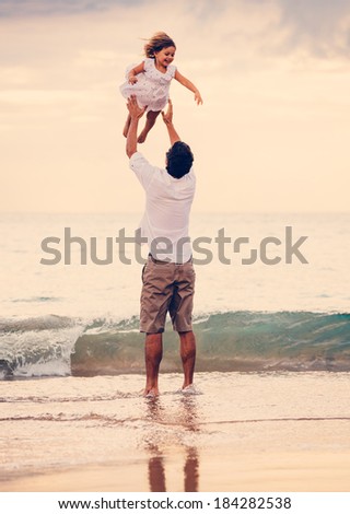 Healthy Father and Daughter Playing Together at the Beach at Sunset. Happy Fun Smiling Lifestyle