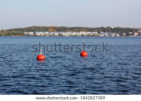 Red buoys in the water area of the town