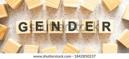 The word consists of wooden cubes with letters, top view on a light background.