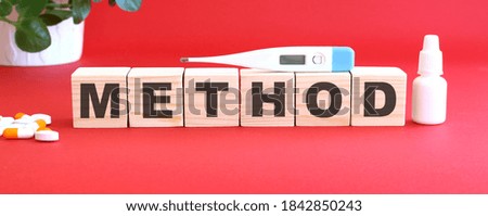 The word METHOD is made of wooden cubes on a red background. Medical concept.