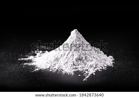 Titanium dioxide (TiO2) powder for cosmetics, isolated black background Royalty-Free Stock Photo #1842873640