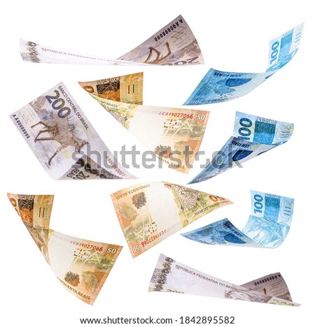 several banknotes from brazil falling on white background, 200, 100 and 50 reais falling