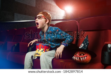 screaming boy in cinema watching 3d movie with pumpkin head