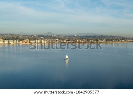 sailboat, paddle boards on Mission Bay San Diego CA bright sunny day