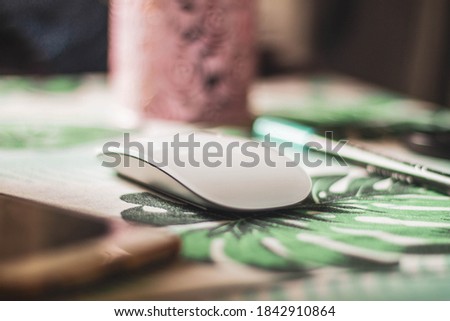 white computer mouse on patterned table