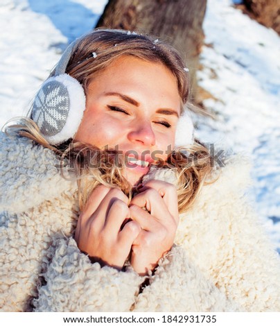 young pretty teenage hipster girl outdoor in winter snow park having fun, lifestyle people concept