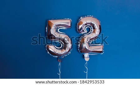 Number fifty-two, it's a balloon shaped like a number fifty-two