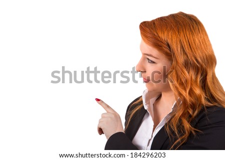 Young red head business woman pointing or showing with copy space, isolated on white background.