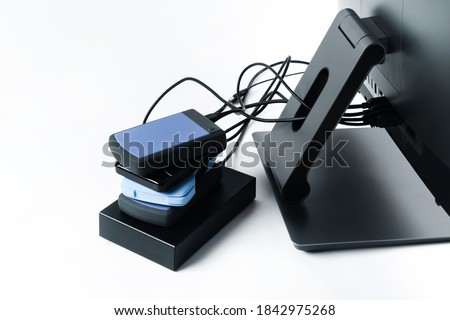Multiple external hard drives connected to a monoblock on a white background.Computer with hard drive