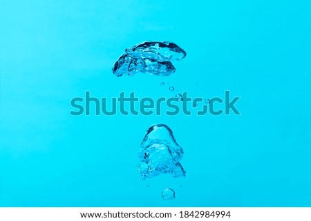 Big air bubble on blue water ,isolated on blue background.