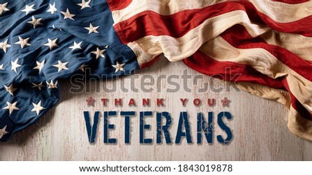Happy Veterans Day concept. American flags against vintasge wooden  background. November 11.