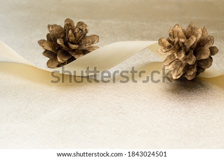 PINE CONES , BEAUTIFUL RIBBON AND NEW YEAR'S SHINY BALL.Christmas decorations on white background. SELECTIVE FOCUS