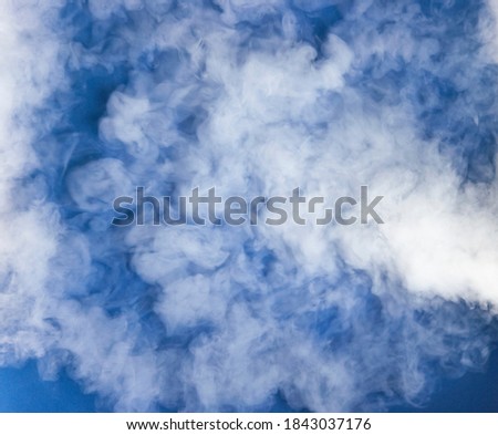 Photo of realistic clouds on blue dark background.