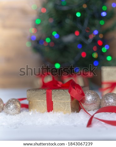 Close-up of Christmas present in wrapping paper are on the floor under the Christmas tree