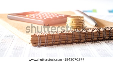 Stacked of Coins with calculator,tax form,notes,Income Tax Raise Concept.