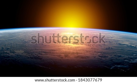 Sunlight over earth with light reflection on earth in the morning. Concept about starting a new day or new year. Blue planet among space in the universe. Elements of this image furnished by NASA.
