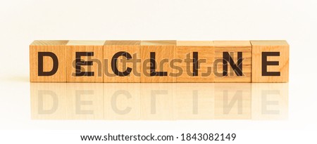 Wooden Blocks with the text: decline. The text is written in black letters and is reflected in the mirror surface of the table. New business relaunch startup concept.