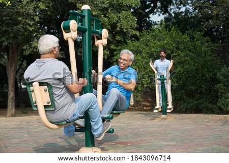 Indian senior males enjoying the exercises at park Royalty-Free Stock Photo #1843096714