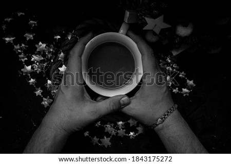 
coffee with milk in a man's hand for new year