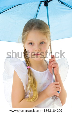 Little girl under an umbrella.Concept style and fashion. Isolated