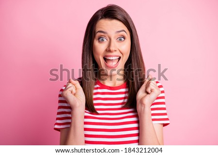 Photo of crazy happy brunette straight hair lady hands fists yelling smiling wear stripy red white cloth isolated over pink color background