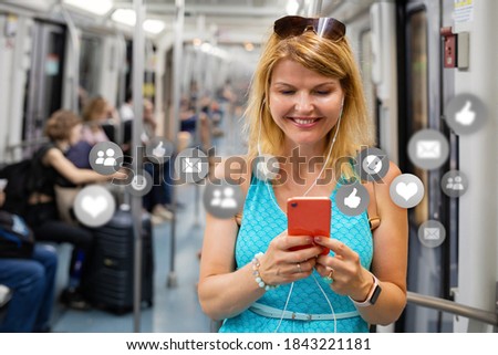 Woman using different apps and services on her mobile phone while riding in train