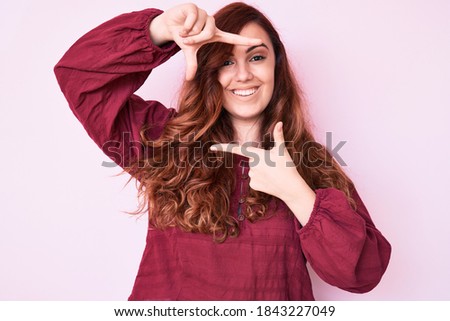 Young beautiful woman wearing casual winter sweater smiling making frame with hands and fingers with happy face. creativity and photography concept. 