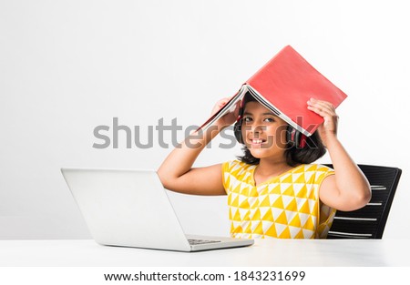 Pretty stylish Indian asian schoolgirl studying attending online lesson at home, social distance during quarantine, self-isolation, online education concept, home schooler