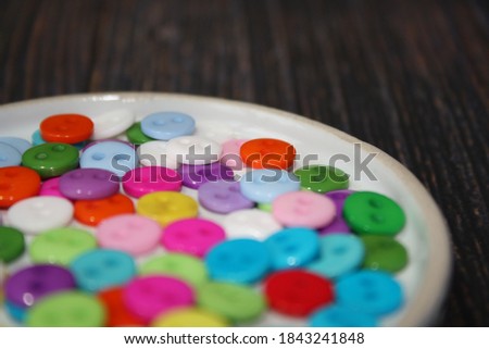 Colorful button on a brown background