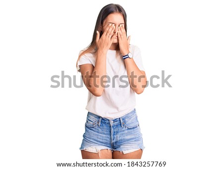 Beautiful caucasian woman wearing casual white tshirt rubbing eyes for fatigue and headache, sleepy and tired expression. vision problem 