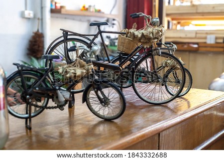 Toys metal classic bicycles display on wooden table, soft selective focus