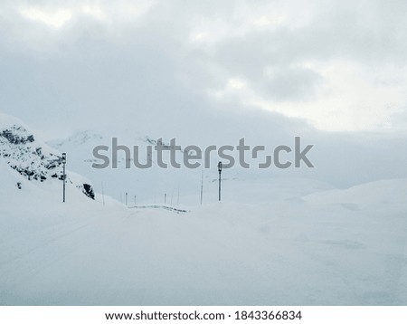 Driving through snowy white road and landscape in Norway.