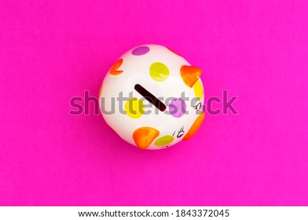 Piggybank on a red background. to save , saving money for affordable things, financial concept .Piggybank or deposit box on a wood background, depict saving money to make a trust fund for children