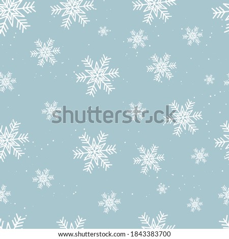 Seamless vector pattern with white snowflakes on the blue background