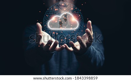 Man holding virtual cloud computing on hand with connection line.Cloud computing is system for sharing download and upload big data information. Royalty-Free Stock Photo #1843398859