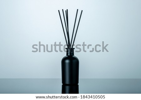 Luxury black glass bottle of home scent Royalty-Free Stock Photo #1843410505